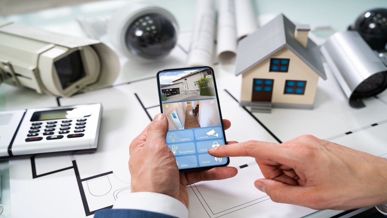 bigstock-person-hand-using-home-securit-351920501